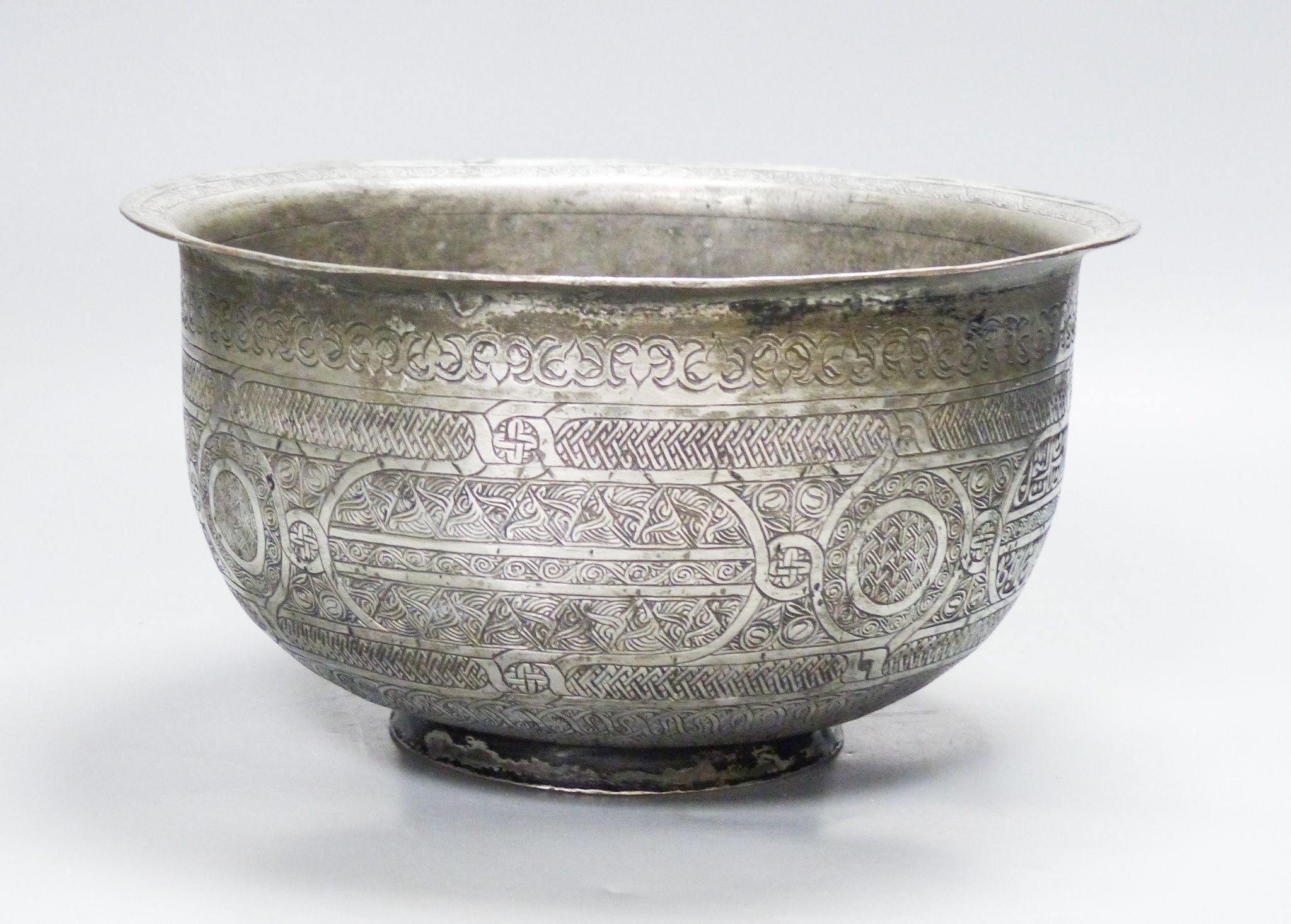 A Mamluk style tinned copper inscribed bowl, 22.5 cm diameter